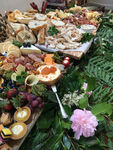 This grazing table included  an antipasto, sweets selection  and hot chicken.  All set up and ready in a private house for the guests to enjoy after the wedding ceremony.  We also finished the table with some beautiful foliage around the table.